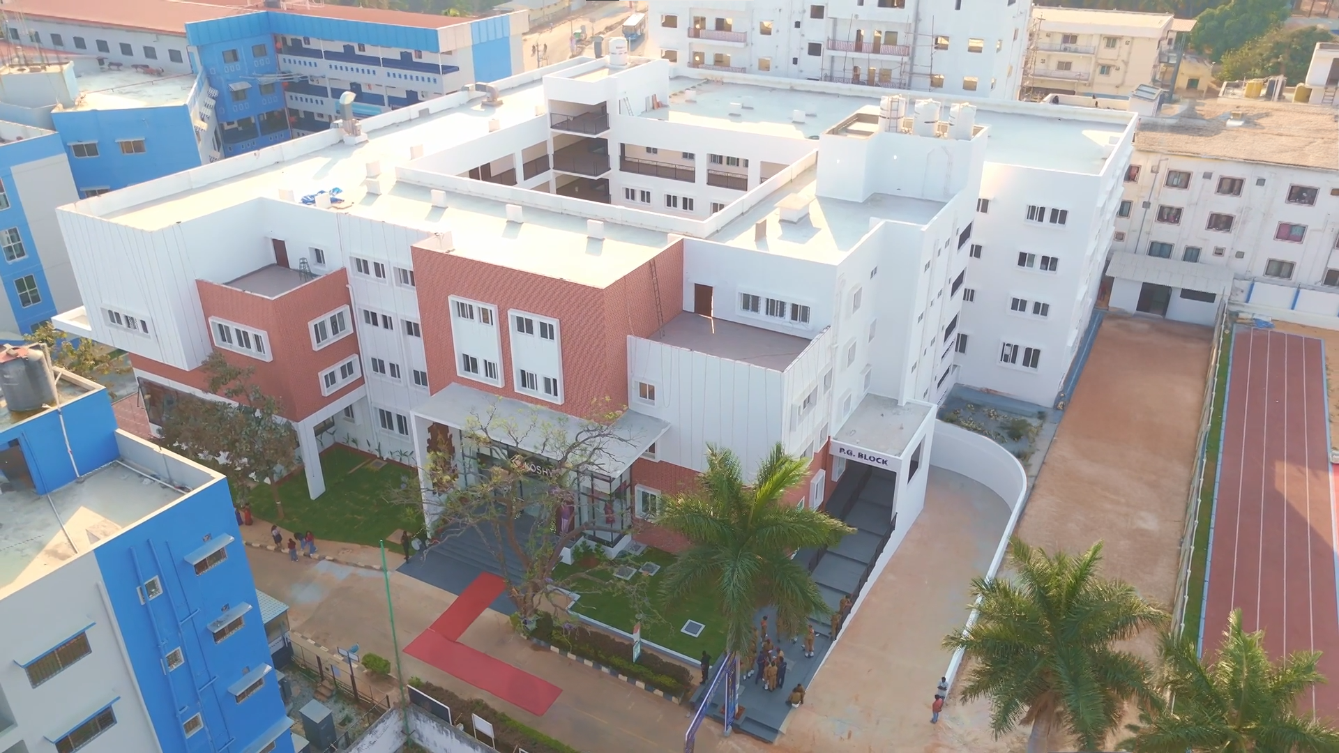 Aerial view of the Koshys Institute of Technology campus with academic blocks and sports courts